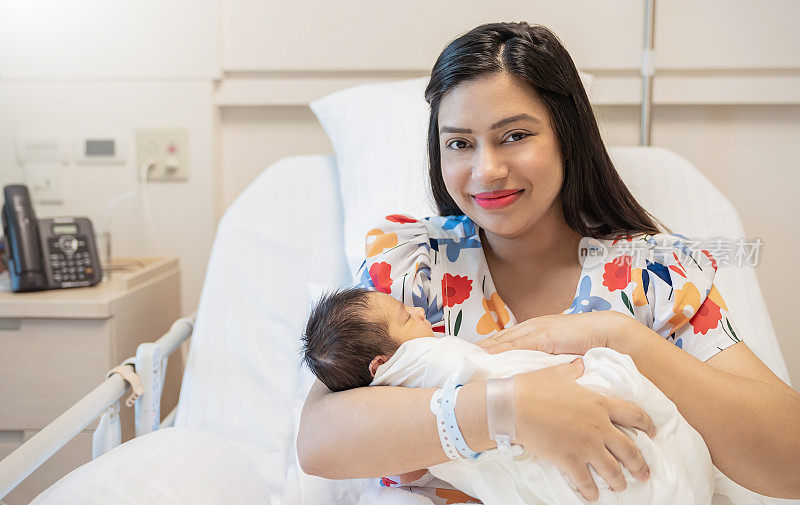 Closeup portrait of young asian Indian hispanic mother day holding newborn baby with copy space. Healthcare and medical daycare nursery love lifestyle together single mom motherâs day holiday concept